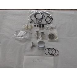 Club Car Engine Rebuild Kit FE290 1992-UP, featuring various mechanical components such as gaskets, rings, and a metal cylinder, arranged on a white surface.